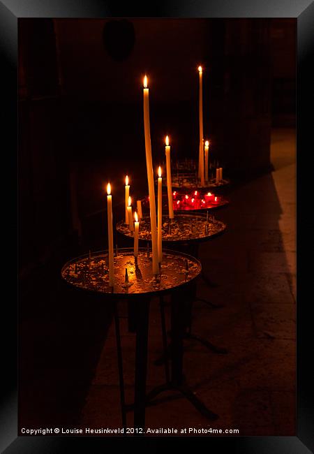 Lit candles in a church Framed Print by Louise Heusinkveld