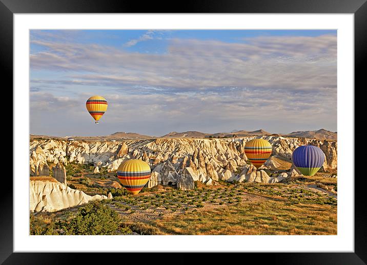 Balloons drifting through Cappadocia gorge Framed Mounted Print by Arfabita  