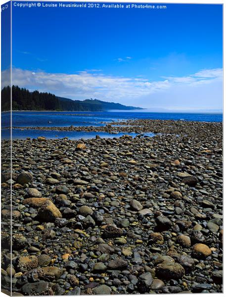 Pebble beach at low tide Canvas Print by Louise Heusinkveld