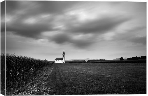 Storm clouds gather over church Canvas Print by Ian Middleton