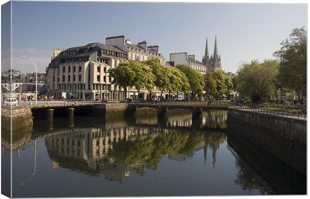 River reflections in a Quimper city scene Canvas Print by Simon Armstrong