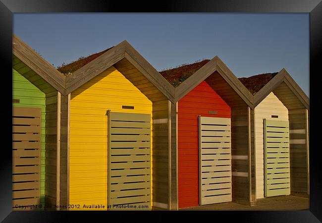 Vibrant Beach Huts at Sunrise Framed Print by Jim Jones