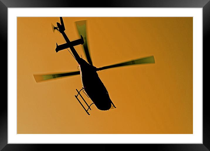 helicopter silhouette in flight Framed Mounted Print by Arfabita  