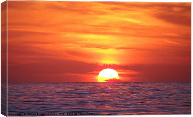 Ball of Fire Setting on The Sea Canvas Print by Susan Medeiros