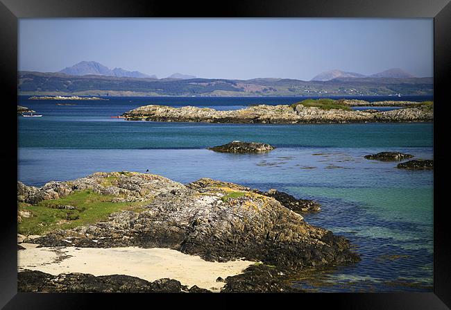 Rocky beach, Skye backdrop, West Scotland Framed Print by Linda More