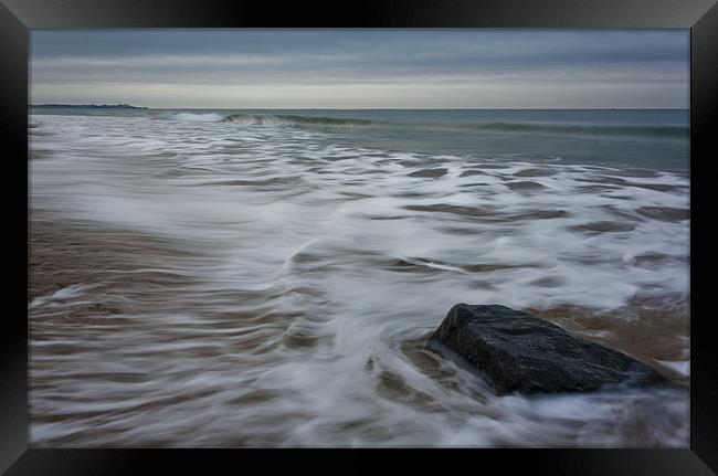 Ebb tide and a rock Framed Print by Ian Jones