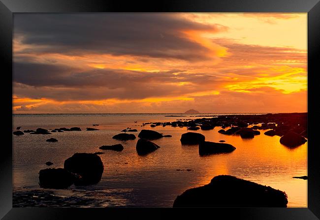 sunset and rocks Framed Print by jane dickie