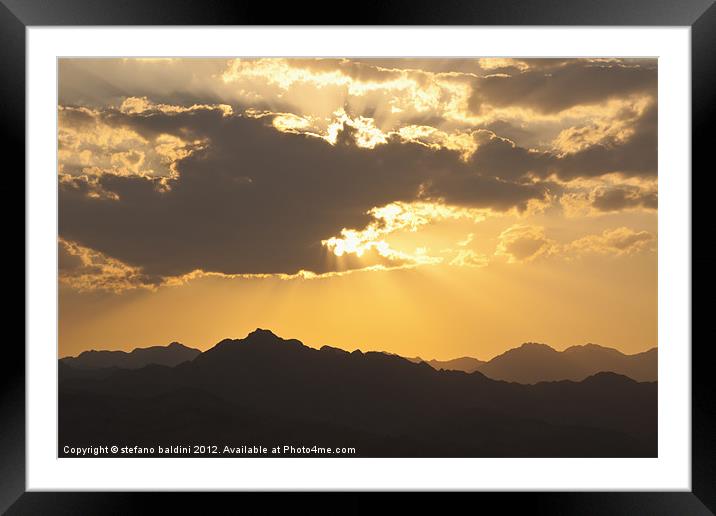 Sunlight through clouds Framed Mounted Print by stefano baldini