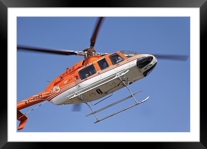 Orange white helicopter hovers over Kashmir Framed Mounted Print by Arfabita  