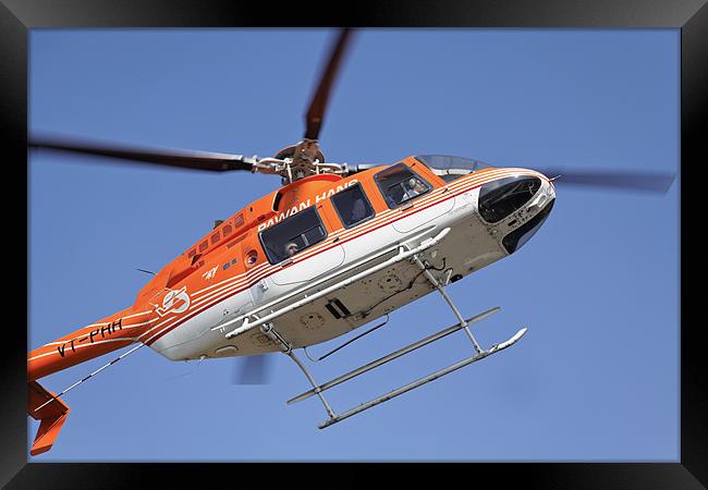Orange white helicopter hovers over Kashmir Framed Print by Arfabita  