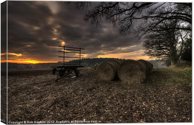 Trailer & the bales at dusk Canvas Print by Rob Hawkins