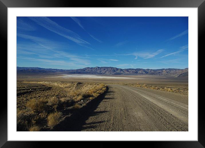 Desert road to salt flats and mountain chains, Nev Framed Mounted Print by Claudio Del Luongo
