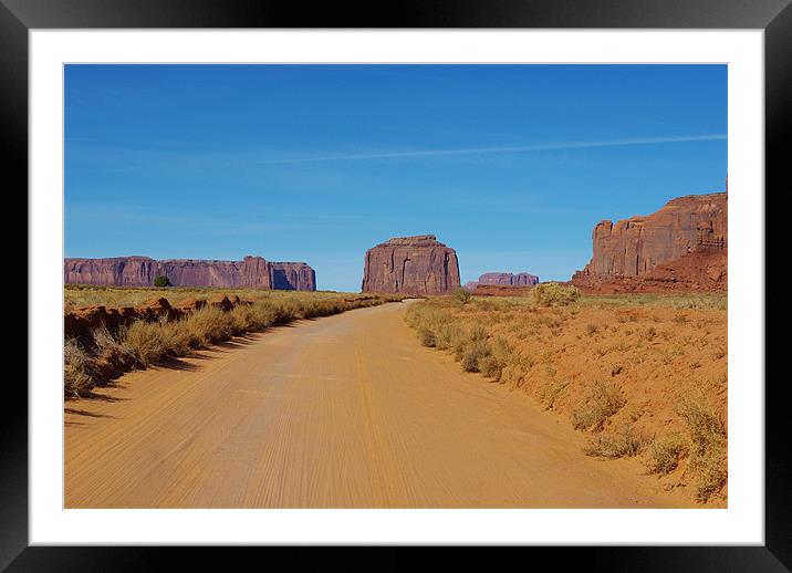 Sand road across Monument Valley, Arizona Framed Mounted Print by Claudio Del Luongo