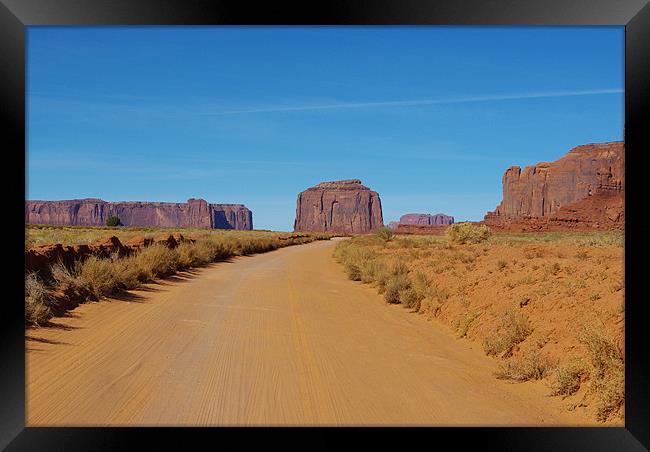 Sand road across Monument Valley, Arizona Framed Print by Claudio Del Luongo