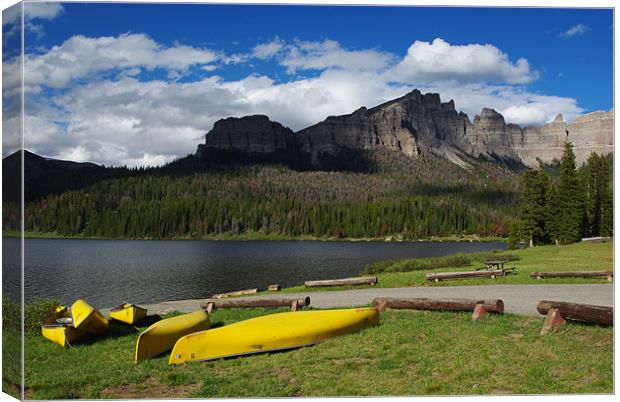 Yellow canoes and Brooks Lake, Wyoming Canvas Print by Claudio Del Luongo
