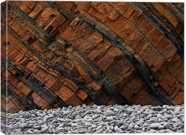 Orange Cliff Face & Grey Pebbles Canvas Print by Dave Bell