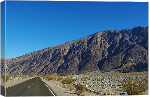 Highway and mountains, Death Valley Canvas Print by Claudio Del Luongo