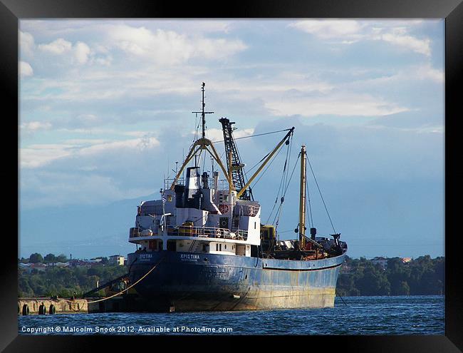 Cargo ship in the islands Framed Print by Malcolm Snook