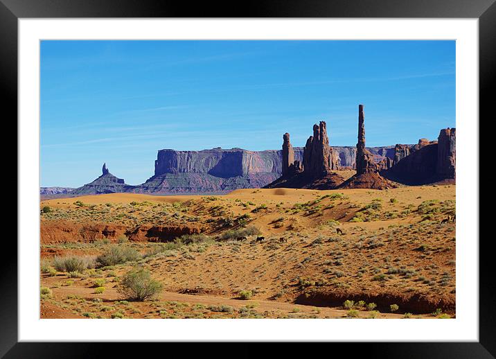 Horses, sand and rock towers, Monument Valley Framed Mounted Print by Claudio Del Luongo