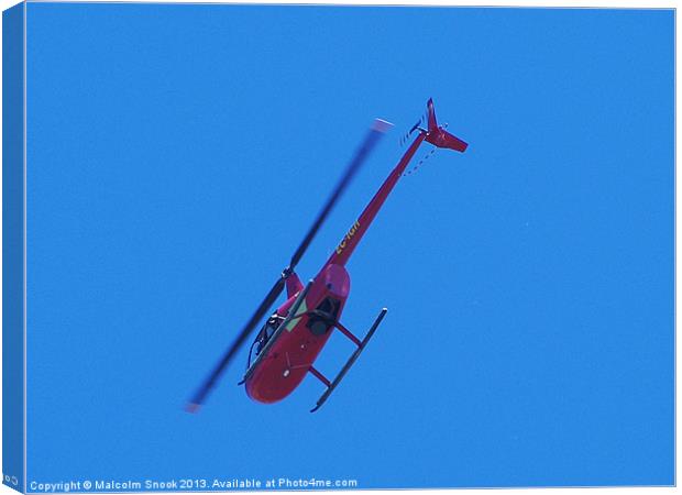 Red R44 helicopter from below Canvas Print by Malcolm Snook