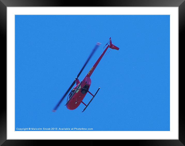 Red R44 helicopter from below Framed Mounted Print by Malcolm Snook