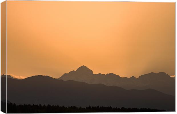 Sunset behind the Julian Alps Canvas Print by Ian Middleton
