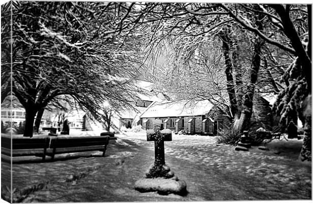 Snow covered Graveyard and church Canvas Print by Doug Lohoar