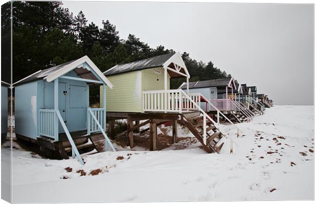 Pastel Beach Huts amid the Snow Canvas Print by Paul Macro