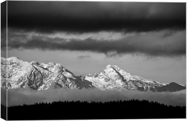 Mountains and clouds Canvas Print by Ian Middleton