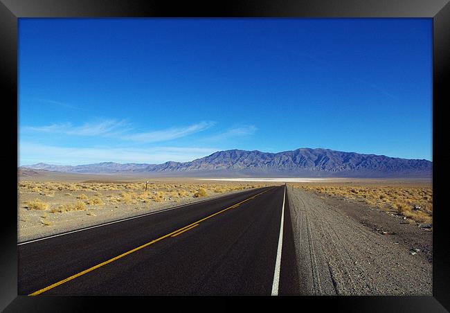 Highway through the desert, Nevada Framed Print by Claudio Del Luongo