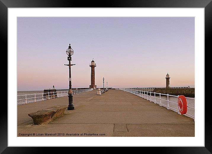 Sunrise over twin lighthouses. Whitby Framed Mounted Print by Lilian Marshall