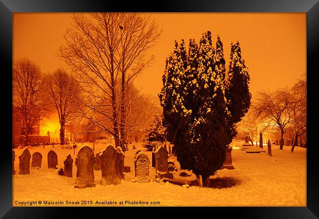 Graveyard in the snow Framed Print by Malcolm Snook