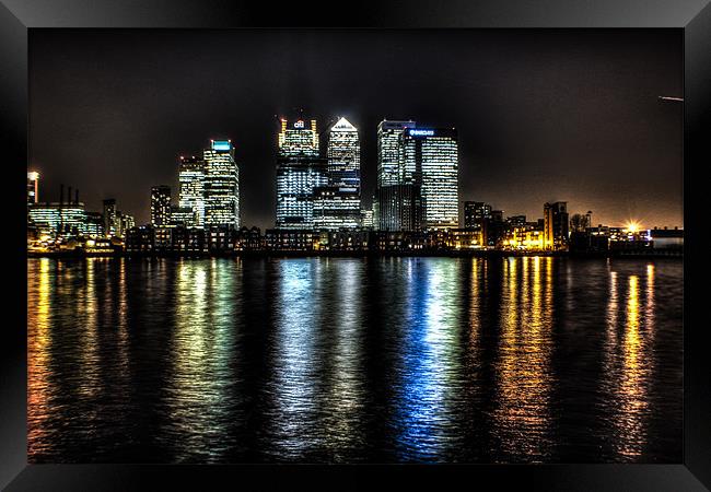 canary wharf across the thames Framed Print by jim wardle-young