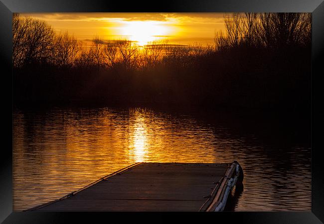 Sunset over lake from pontoon Framed Print by Simon West