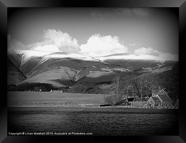 Snow capped mountains at Keswick. Framed Print by Lilian Marshall