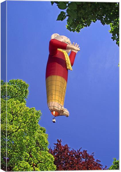 Rupert the Bear Balloon, through trees Canvas Print by Peter Cope