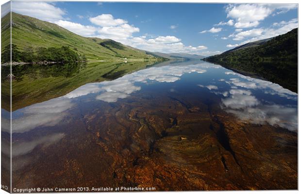 Still clear waters of Loch Arkaig. Canvas Print by John Cameron