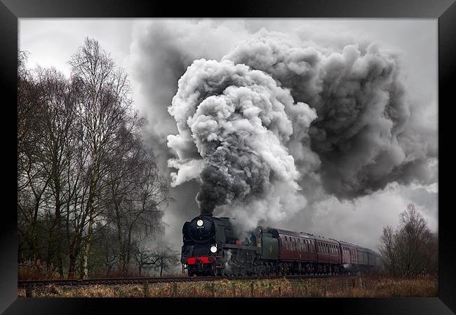 A historic steam locomotive produces volcanic exha Framed Print by Ian Duffield