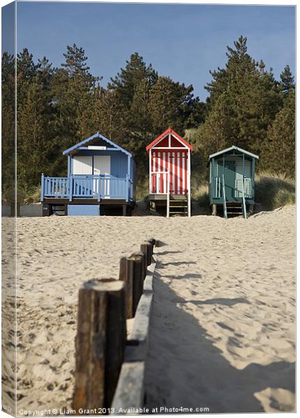 Beach huts and blue sky. Wells-next-the-sea. Canvas Print by Liam Grant