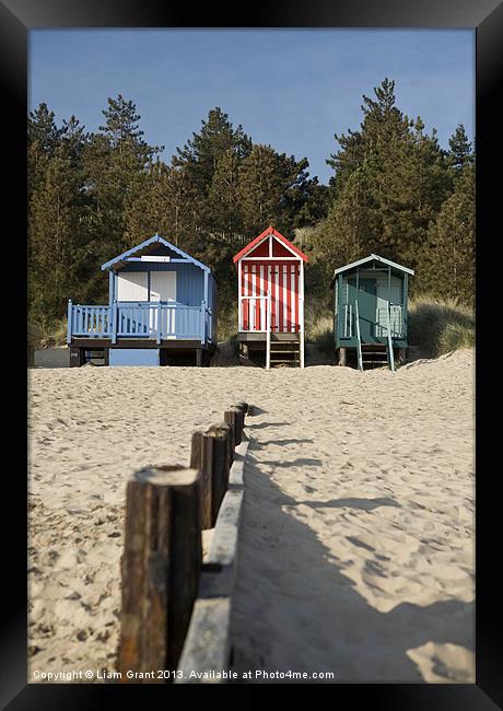 Beach huts and blue sky. Wells-next-the-sea. Framed Print by Liam Grant