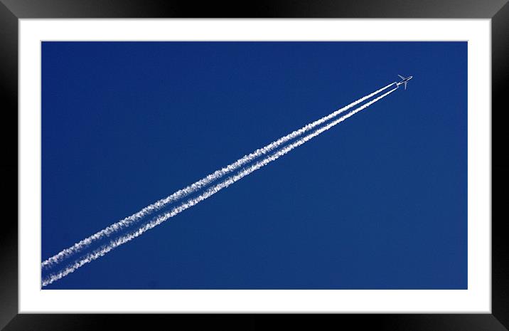 Airplane trail in blue sky Framed Mounted Print by patrick dinneen