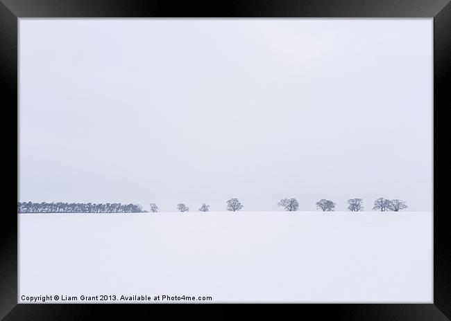 Snow covered field and trees on the horizon. East  Framed Print by Liam Grant
