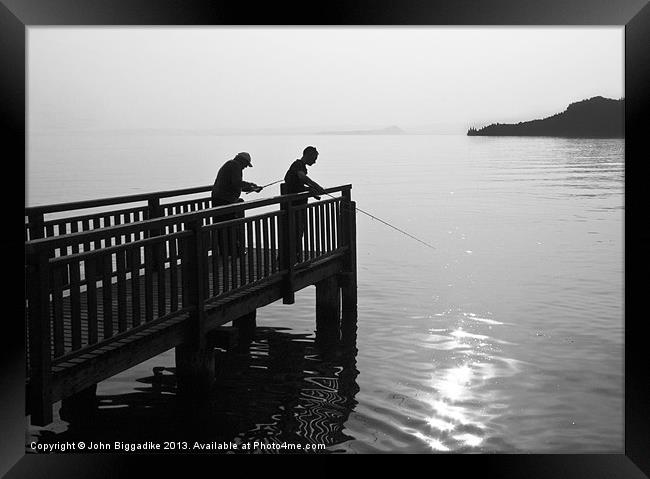 Fishing on Lake Garda Framed Print by John Biggadike