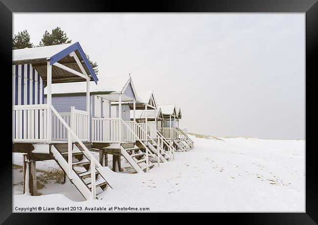 Beach huts covered in snow. Wells-next-the-sea, No Framed Print by Liam Grant