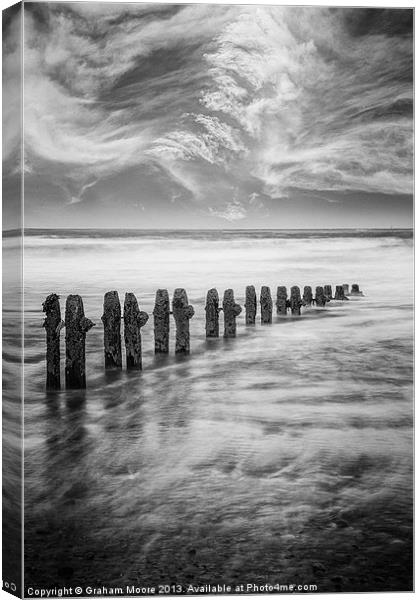 Breakwater and clouds Canvas Print by Graham Moore