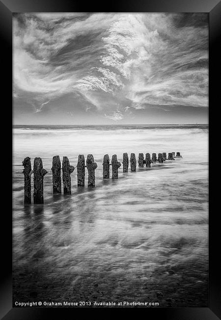Breakwater and clouds Framed Print by Graham Moore