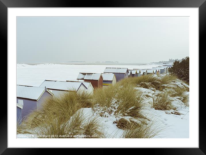 Sand dunes and beach huts covered in snow. Framed Mounted Print by Liam Grant