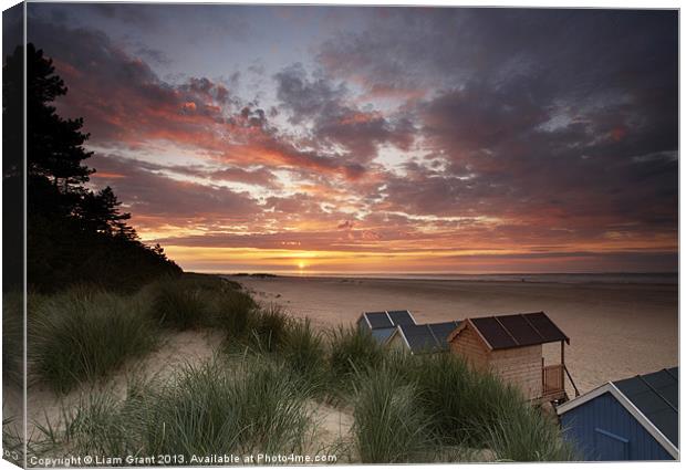 Beach huts and sunset. Canvas Print by Liam Grant