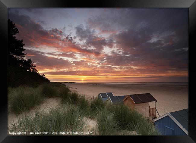 Beach huts and sunset. Framed Print by Liam Grant