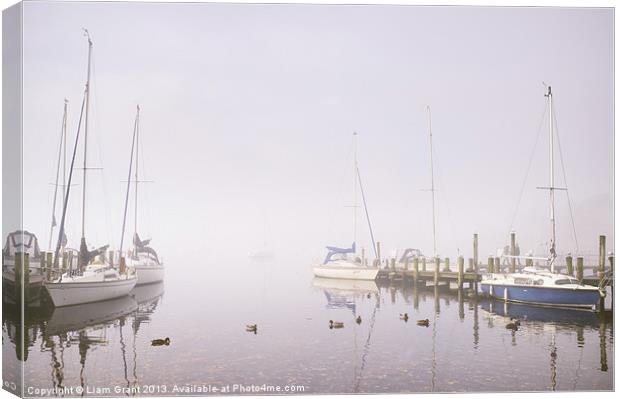 Boats in fog on Lake Windermere. Canvas Print by Liam Grant